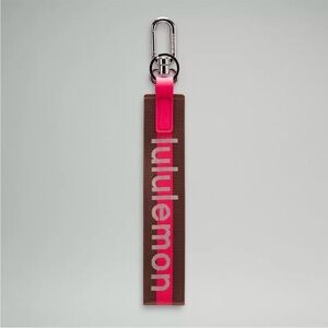 Lululemon Pink and Brown Never lost Word mark Keychain NWOT